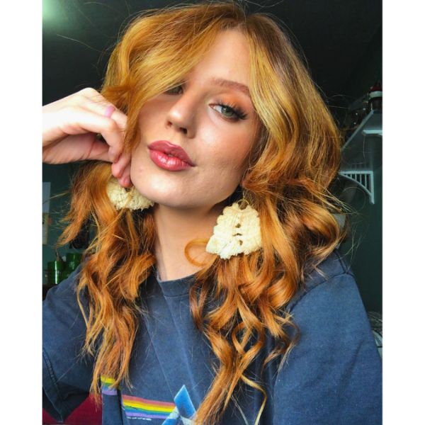 Curly Vibrant Golden Long Long Shag Haircuts for Women with Straight Hair - a woman with a pink floyd blouse