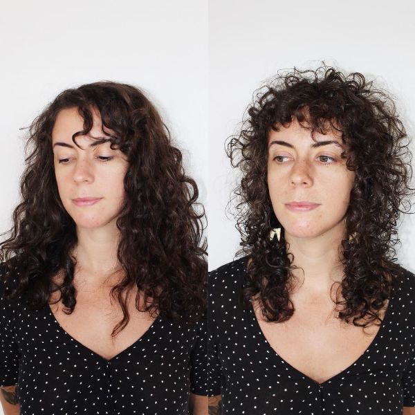 Curly Heavy Layered Hairstyle with Curly Bangs