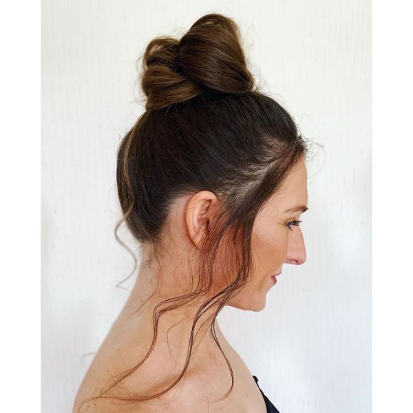 High Messy Bun with Falling Front Pieces for Long Brunette Hair