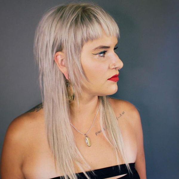 Platinum Blonde Long Shag Cut with Straight Bangs and Long Sideburns