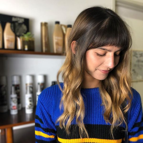 Root Melt Balayage for Wavy Layered Hair with Curved Bangs