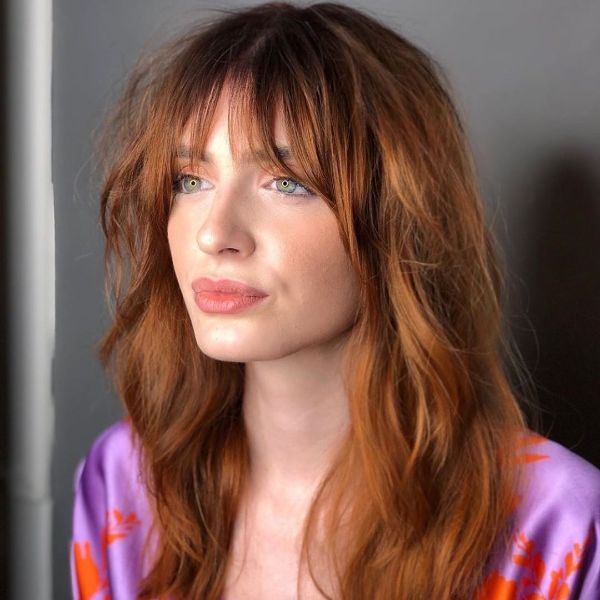 Shaggy Red Layered Hairstyle with Face-framing Bangs