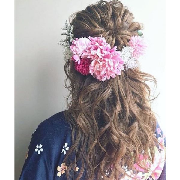 Curly Messy Half Up Half Down Hairstyle with Flower Accessory