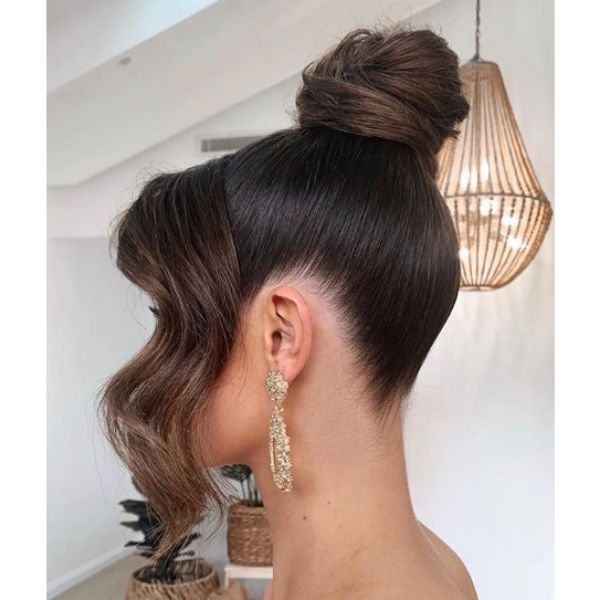 High Bun with Falling Strands Hairstyle