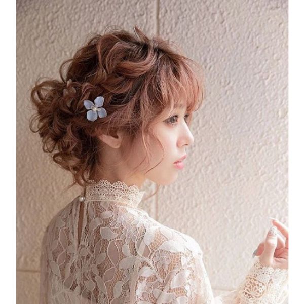 Loose Crown Braid with Falling Strands Hairstyle