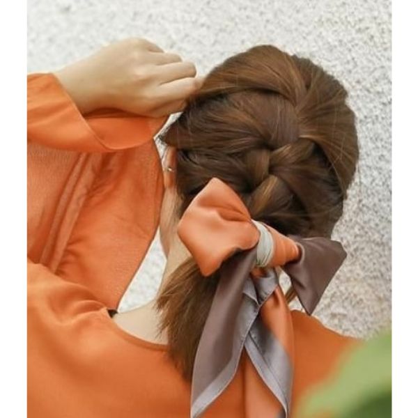 A woman wearing orange dress with hairstyle for school