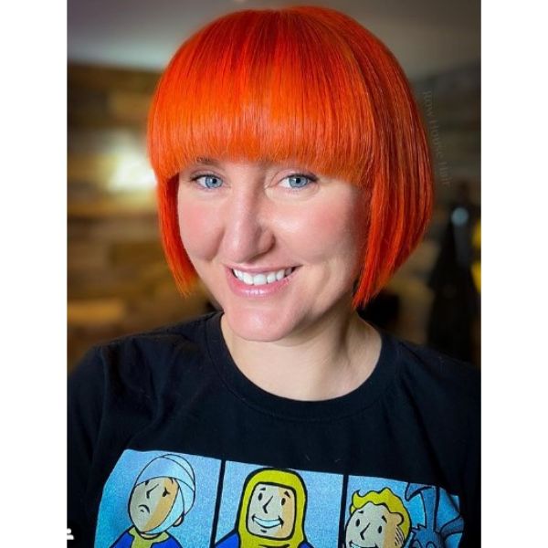  Bright Orange Bob Hairstyle With Thick Bangs For Oval Face