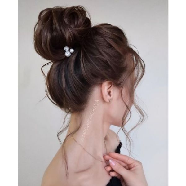 High Negligent Bun With Falling Strands And Beam Hair Pin