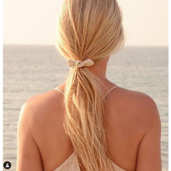 Low Ponytail With Small White Ribbon For Blonde Hair