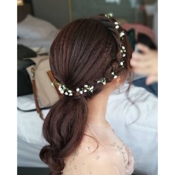  Swirling Low Ponytail With Crown Braid And Wedding Flowers Hairstyle