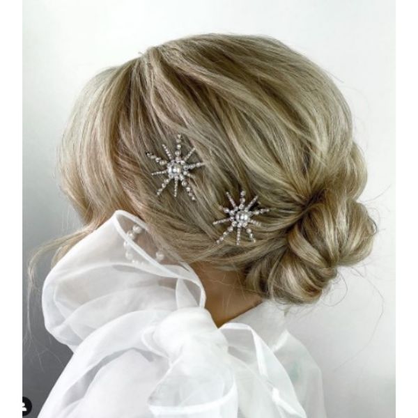 Textured Low Bun Hairstyle With Face Framing Pieces And Star Shaped Hairclips