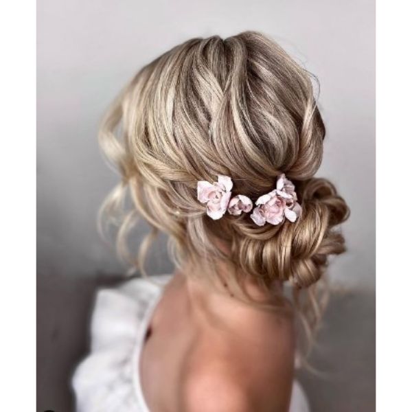 Textured Undone Low Blonde Bun With Rose Pins Wedding Hairstyles