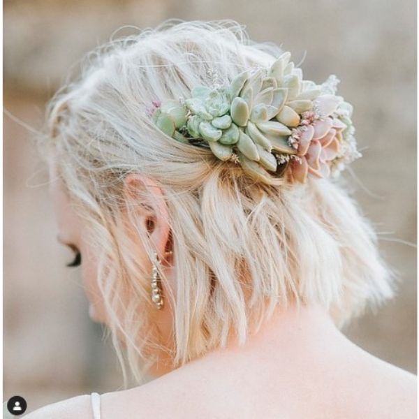a woman with Messy Half Updo With Succulent Flower Accessory
