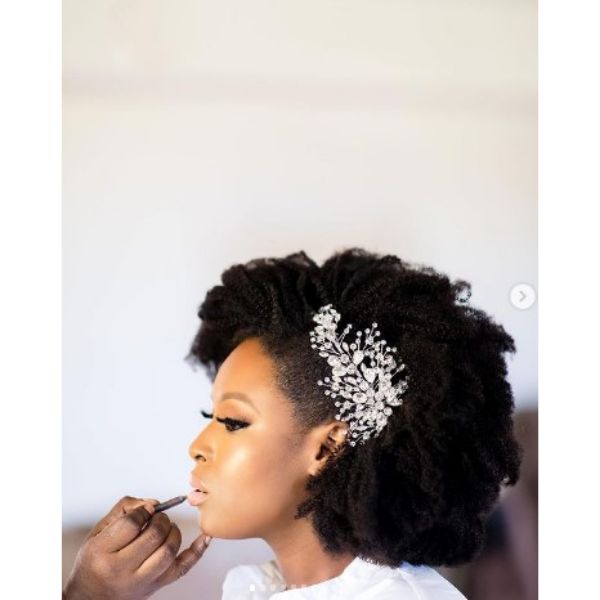 a woman with Short Afro and white floral Headpiece