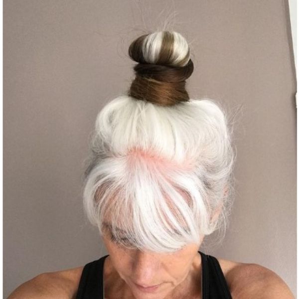  White Sleek High Bun With Brown Insertions Hairstyle For Older Women