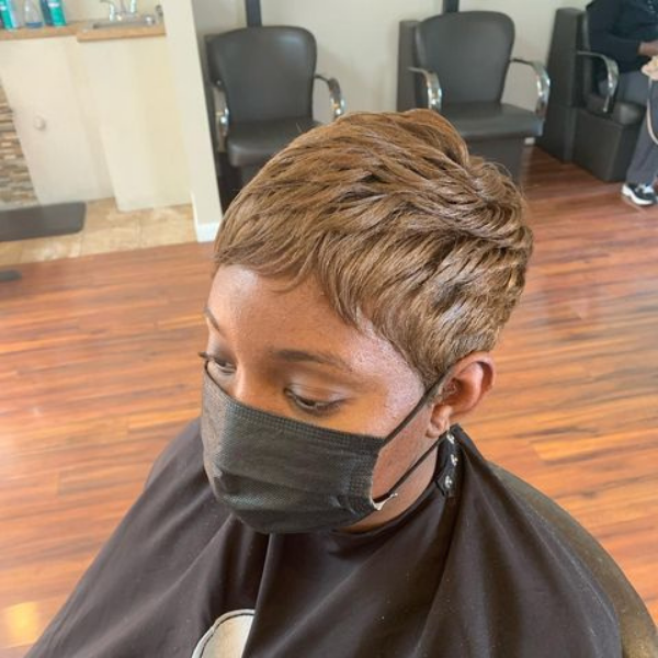 Clean Copper Short Pixie Cut for Black Women - A woman inside a salon