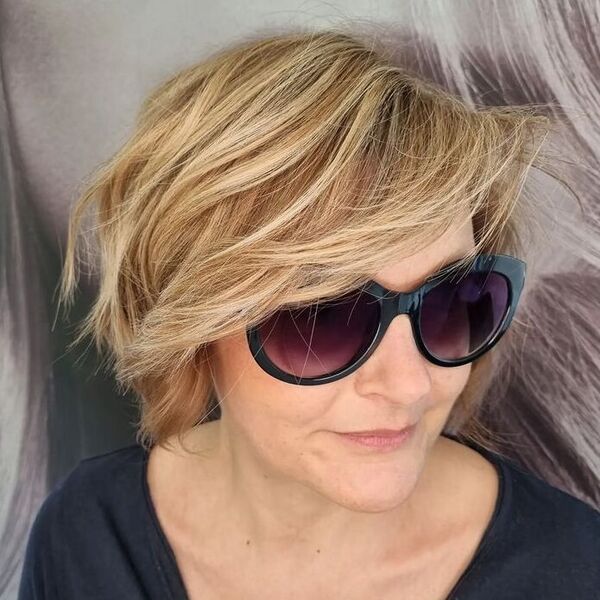 Layered Blonde Bob Hairstyle - a woman wearing a black shirt and sunglasses