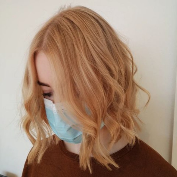 Light Honey Blonde Hairstyle - A woman wearing a blue mask