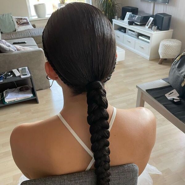 Low Braided Ponytail - A woman wearing a white mermaid tail gown