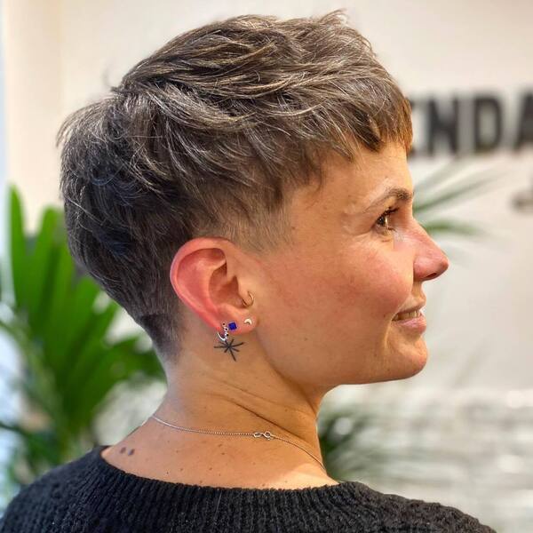 Short Shag Pixie with Bangs Haircut - a woman with minimalist tattoos