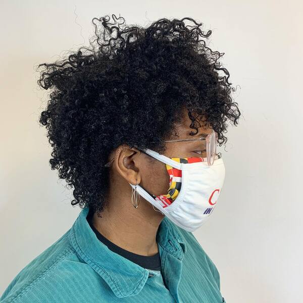 Afro Curly Mullet Hairstyles - a woman wearing a white face mask