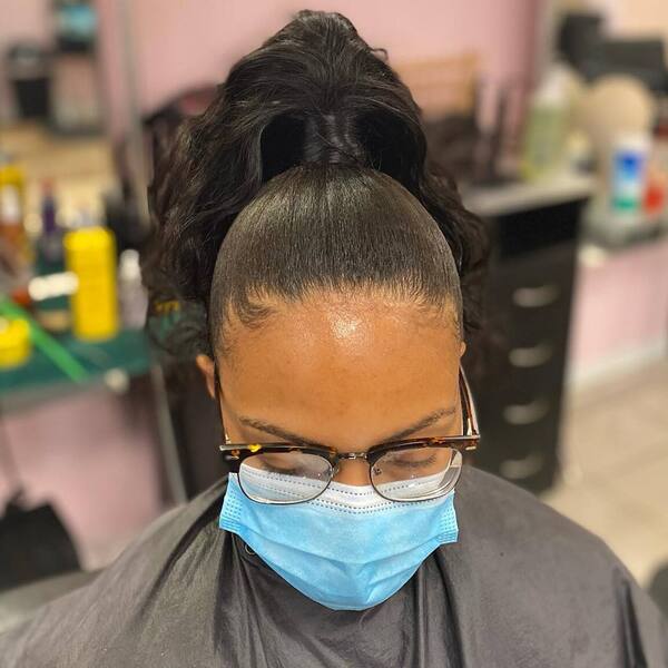 Black Simple Updo Ponytail - A woman with eyeglasses wearing a blue surgical facemask