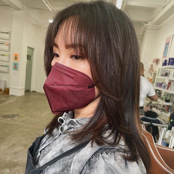 Extra Texture - A woman wearing a maroon KN95 facemask
