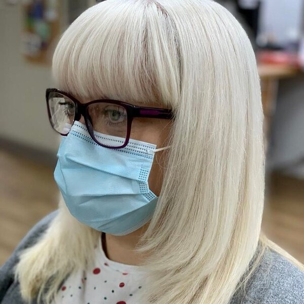 Long Bob with Bangs - A woman wearing a surgical facemask and eyeglasses