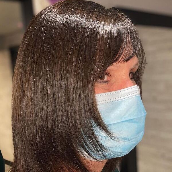 Razor Cut - A woman wearing a surgical facemask