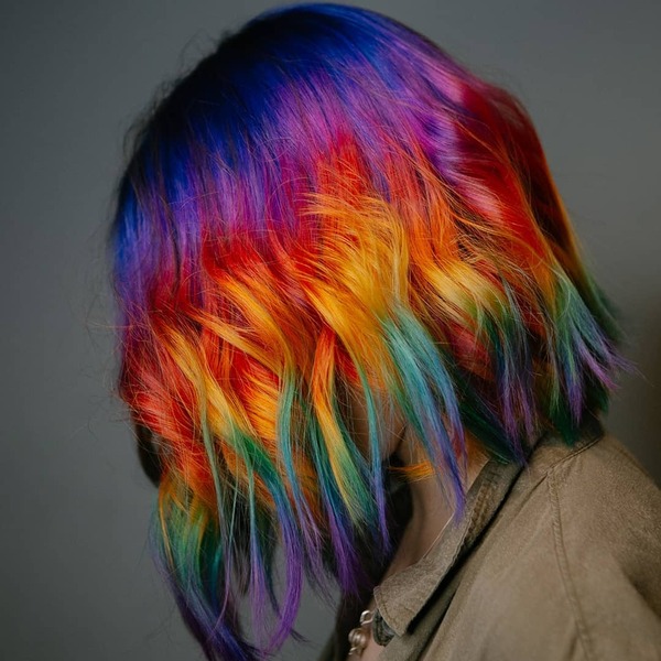 Short Wavy Unicorn and Rainbow Hair - A woman wearing a brown longsleeve