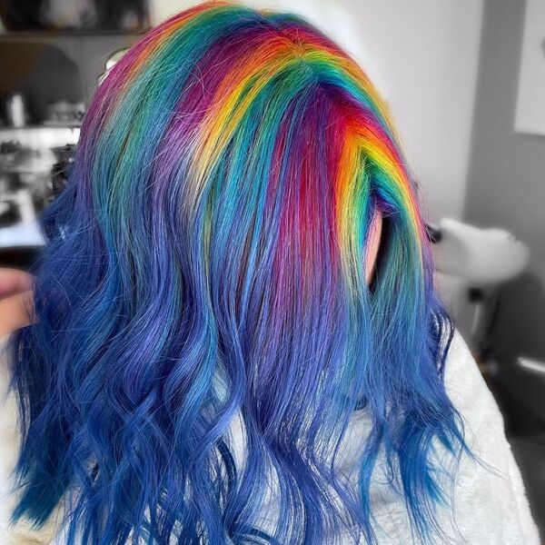Wavy Rainbow Root Hair - A woman inside a salon
