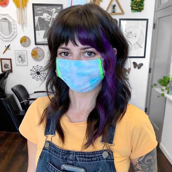 Little Pop of Color with Chopped Bangs - a woman wearing a face mask