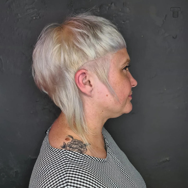Mushroom Mullet with Long Side Burn Haircut - a woman in a side view