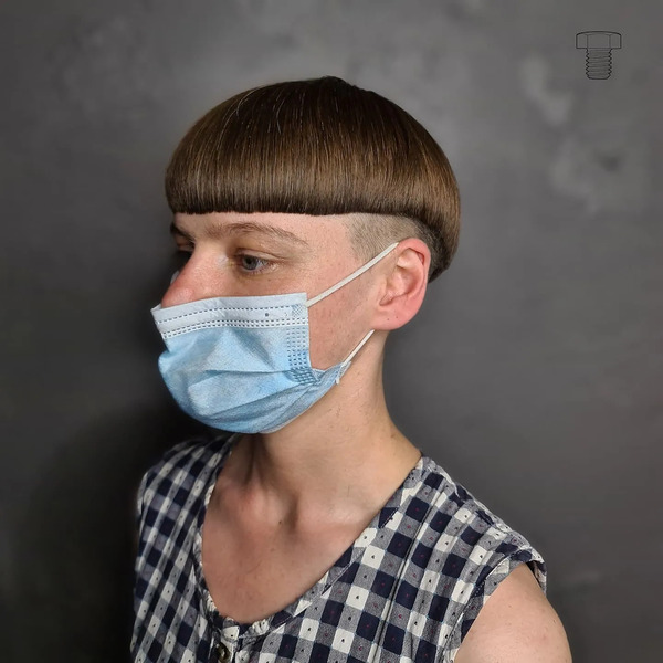 Mushroom with Sharp Edge Cut - a woman wearing a face mask