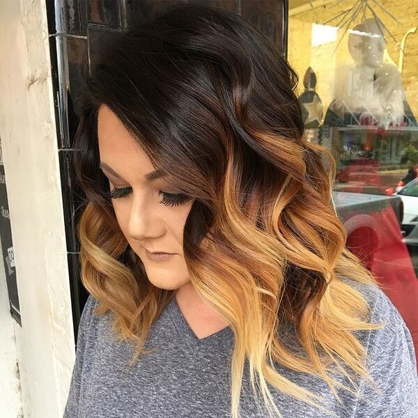 Wavy Black and Toffe Ombre Hairstyle - a woman in a side view