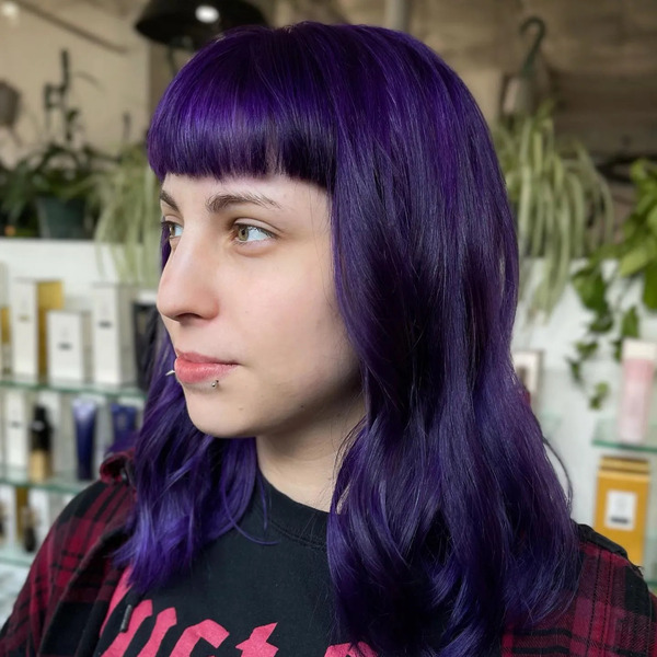 Wavy Hair with Bangs with Purple Black Tones - a woman in a side view