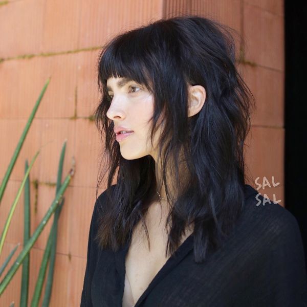 Choppy Long Straight Shag Hairstyles for Women with Bangs - a woman in a black blouse