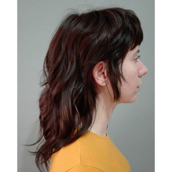 Mullet-Like Long Shag Haircuts for Straight Hair -  a woman with a yellow blouse