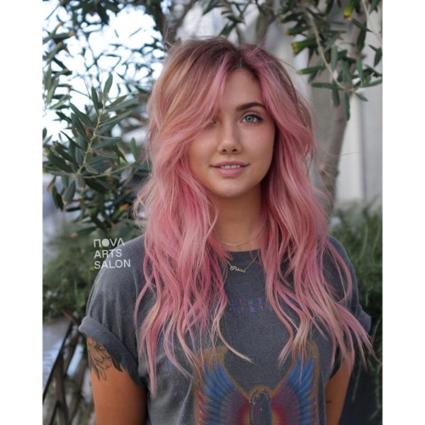  Pastel Pink Long Shag Haircuts for Women with Wavy Hair - a woman with a scarab t-shirt