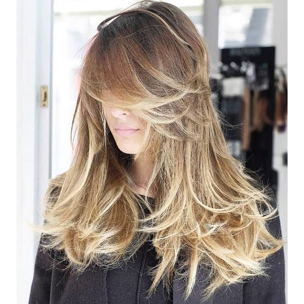 Feathered Layers for Blonde Hair with Baby Lights and Long Bangs