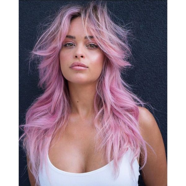 Pink Blonde Long Layered Hairstyle with Dark Roots and Voluminous Bangs