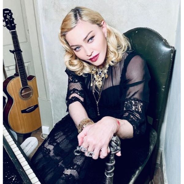 Madonna's Curly Blonde Hairstyle With Dark Roots