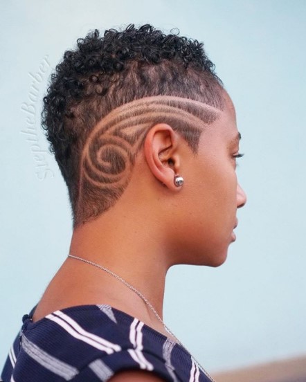 a woman with High Curly Fade with Circular Razor Side Design