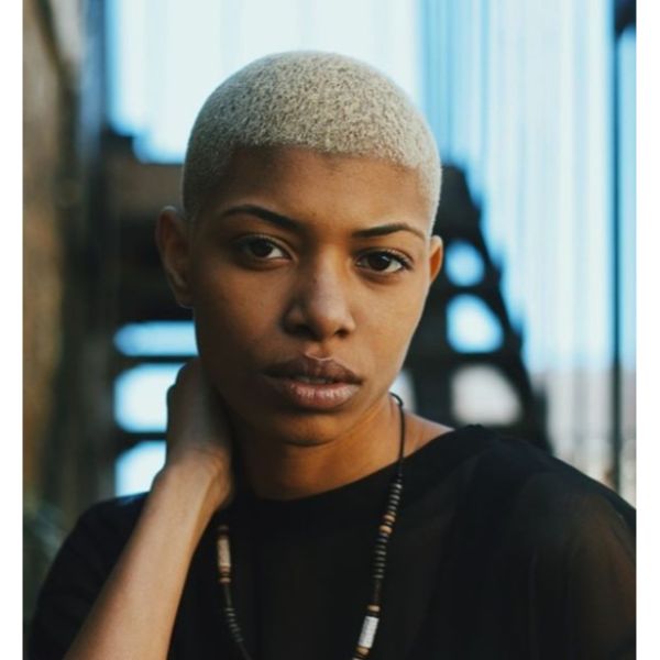 a woman with Platinum Buzz Cut wearing black shirt