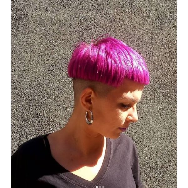 A girl outdoor with her crazy pink bowl haircut 