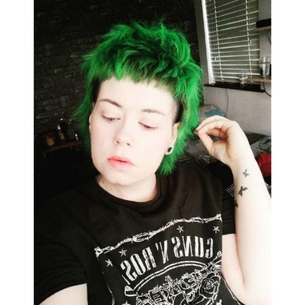 A girl with her emerald green short spiky mullet hairstyle