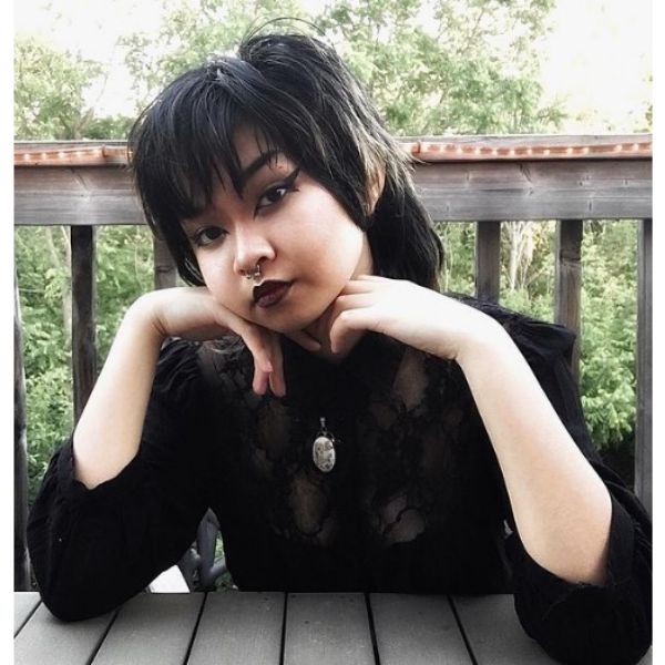 A girl outdoor with her goth mullet hairstyle
