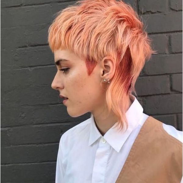 A girl outdoor with her peach pink mullet haircut