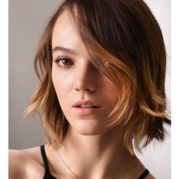 A girl with her soft-feathered bob with subtle balayage hairtstyle