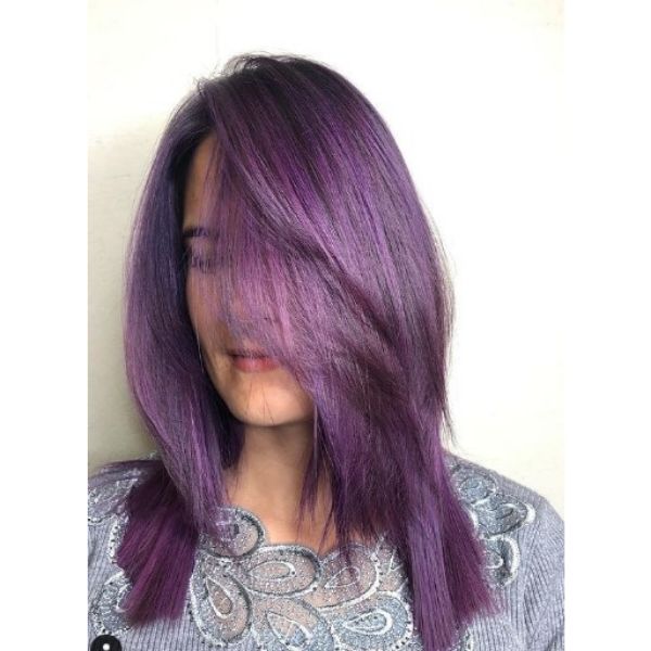 A girl with her soft feathered purple hairstyle